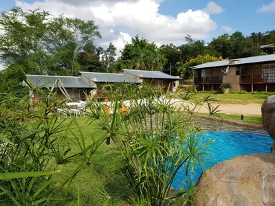 a group of houses with a pool of water at Numbi Hills Self-Catering in Hazyview