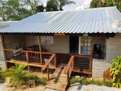 a house with a metal roof on a deck at Numbi Hills Self-Catering in Hazyview