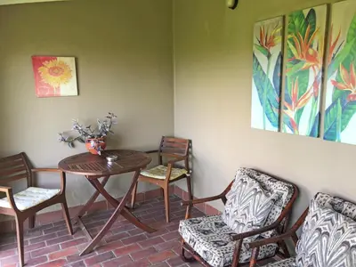 a dining room with a table and chairs at Hills and Dales Accommodation in Lanseria