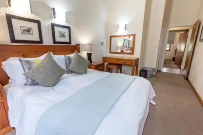 a bedroom with a large white bed with pillows at Legend Safaris 257A - in Kruger Park Lodge in Hazyview