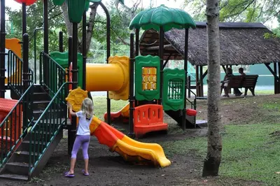 a young girl playing on a slide at a playground at Legend Safaris 257A - in Kruger Park Lodge in Hazyview