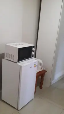 a microwave sitting on top of a refrigerator at Valley Guest House in Pretoria