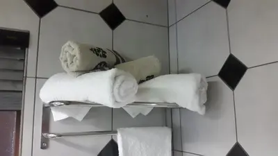 a towel rack with towels on it in a bathroom at Jabula Kruger Safari Lodge in Marloth Park