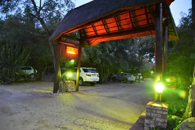 a pavilion with cars parked in a parking lot at night at Jabula Kruger Safari Lodge in Marloth Park