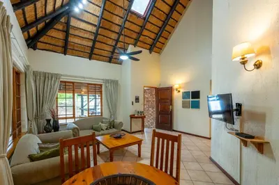 a living room with a couch and a table at Kruger Park Lodge Unit No. 543 in Hazyview