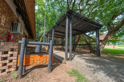 a building with a porch with a roof at Kruger Park Lodge Unit No. 543 in Hazyview