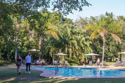 a group of people walking around a swimming pool at Kruger Park Lodge Unit No. 543 in Hazyview