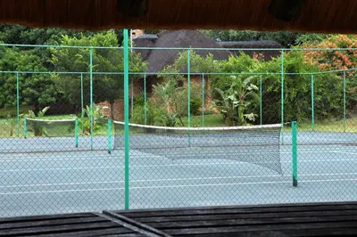a tennis court with two tennis nets on it at Kruger Park Lodge Unit No. 543 in Hazyview