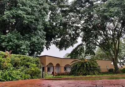 a building with a fence in front of it at Boschoek Farm in Tzaneen
