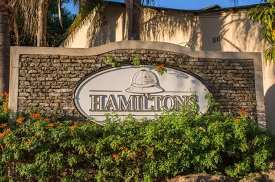 a sign for the hampton inn at Hamiltons Lodge & Restaurant in Malelane