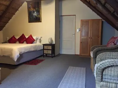 a bedroom with a bed with red pillows at ConcordiaVOC in Lanseria