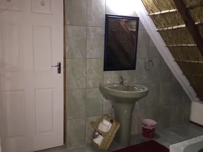a bathroom with a sink and a mirror and a door at ConcordiaVOC in Lanseria