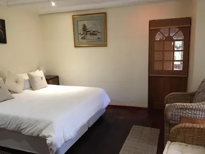 a bedroom with a large white bed and a window at ConcordiaVOC in Lanseria