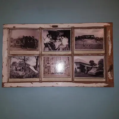 an old window with pictures on the wall at Stoep At Steenbok Self Catering in Komatipoort