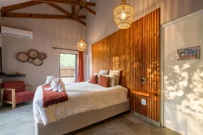 a bedroom with a bed with two stuffed animals on it at The Baobab Bush Lodge and Villa in Hoedspruit