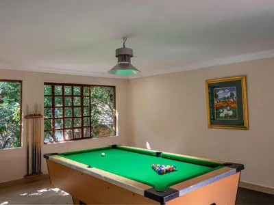a room with a pool table in a room at Casa Albergo Corporate Guest House in Pretoria