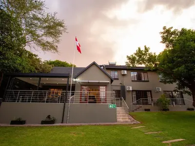 a house with a canadian flag in front of it at Casa Albergo Corporate Guest House in Pretoria