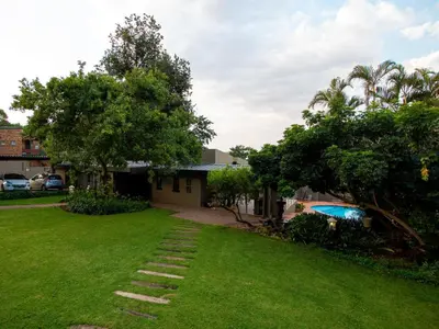 a house with a lawn with a stairway at Casa Albergo Corporate Guest House in Pretoria