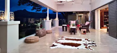 a lobby of a building with a rug on the floor at umSisi House in White River