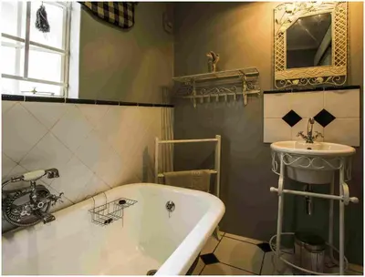 a bathroom with a tub and a sink at De Ark Guest House in Lydenburg