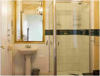 a bathroom with a sink and a shower with a mirror at De Ark Guest House in Lydenburg