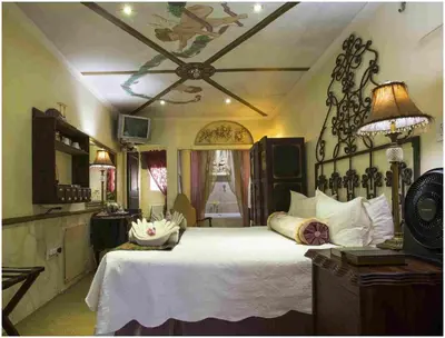 a bedroom with a large white bed in a room at De Ark Guest House in Lydenburg