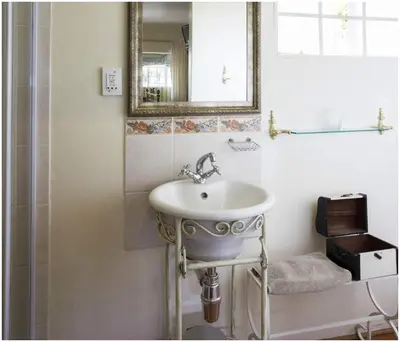 a bathroom with a sink and a mirror at De Ark Guest House in Lydenburg