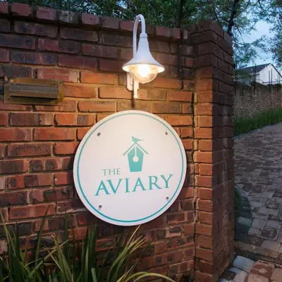 a sign for the army hanging on a brick wall at The Aviary in Pretoria
