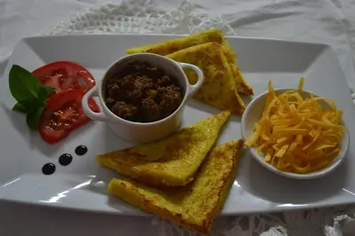 a plate of food with toast and salsa and cheese at Dara Guest House in Trichardt