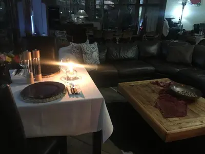 a living room with a table and a couch at Dara Guest House in Trichardt