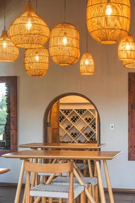 a dining room with a table and lights at Lion Sands Narina Lodge in Sabi Sand Game Reserve