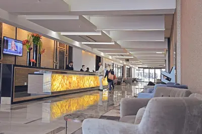 a lobby with couches and a bar in a building at The Capital Menlyn Maine in Pretoria