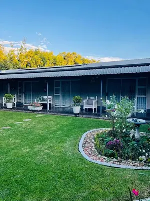 a building with a yard with a garden sidx sidx sidx at Pari Guest House in Middelburg