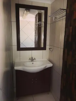 a bathroom with a sink and a mirror at AAA Rose Garden Guesthouse in Naboomspruit