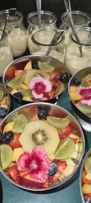 a table topped with bowls of fruit and vegetables at The Leopard Tree in Polokwane