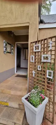 a house with a planter in front of a building at The Leopard Tree in Polokwane