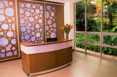 a lobby with a reception desk with a vase of flowers at Hudson House in Pretoria