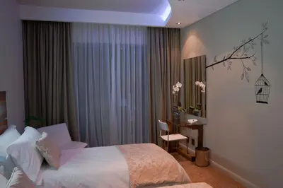 a hotel room with a bed and a desk and a window at Hudson House in Pretoria