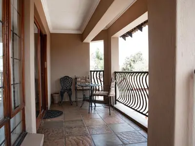 a balcony with a table and chairs on it at The Orion Guesthouse in Middelburg