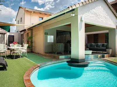 a swimming pool in the yard of a house at The Orion Guesthouse in Middelburg