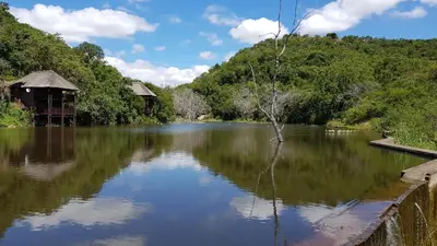 a river with a house in the middle of it at Sunset Creek Game Lodge in Karino