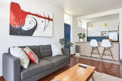a living room with a couch and a table at House Sandrock Muckleneuk Selfcatering apartment in Pretoria
