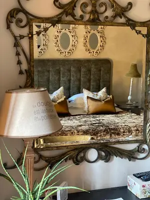 a bedroom with a bed with a mirror at Godiva Spa & Guesthouse in Groblersdal