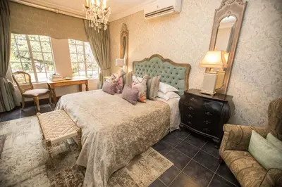 a bedroom with a bed with stuffed animals on it at Godiva Spa & Guesthouse in Groblersdal