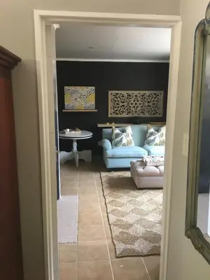 a living room with a couch and a table at Alibama House in Nelspruit