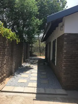 a walkway next to a brick building at Alibama House in Nelspruit