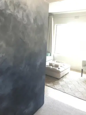 a room with a bed and a wall at Alibama House in Nelspruit