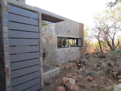 a stone house with a window on the side of it at Kukama's Rest at Zebula 317 in Mabula