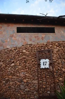 a stone wall with a sign on top of it at Kukama's Rest at Zebula 317 in Mabula