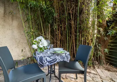 a table and chairs with a table and flowers on it at Craigivar Guesthouse in Pretoria